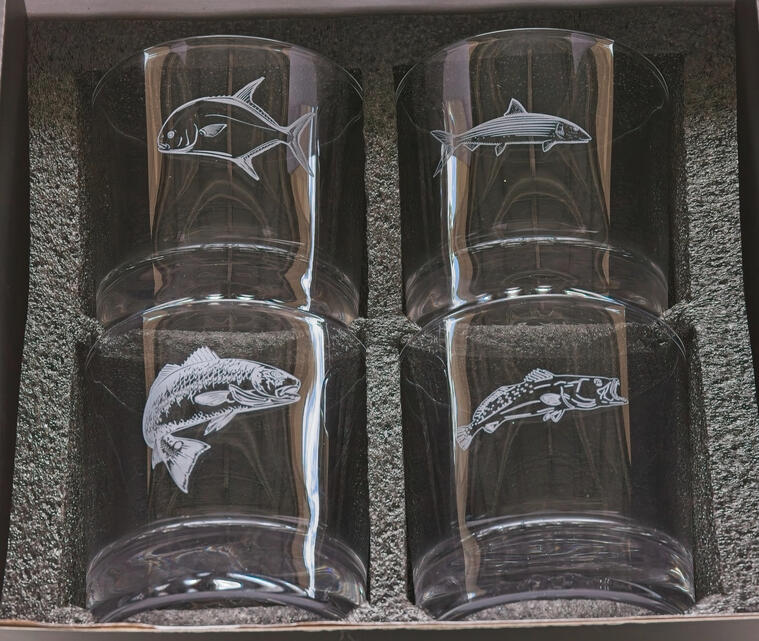 Premium 4-piece whiskey glass gift set featuring custom laser-engraved Florida game fish: Redfish, Snook, Tarpon, and Bonefish. The set is presented in a professional foam-lined protective gift box, ideal for anglers and coastal-themed housewarming gifts.